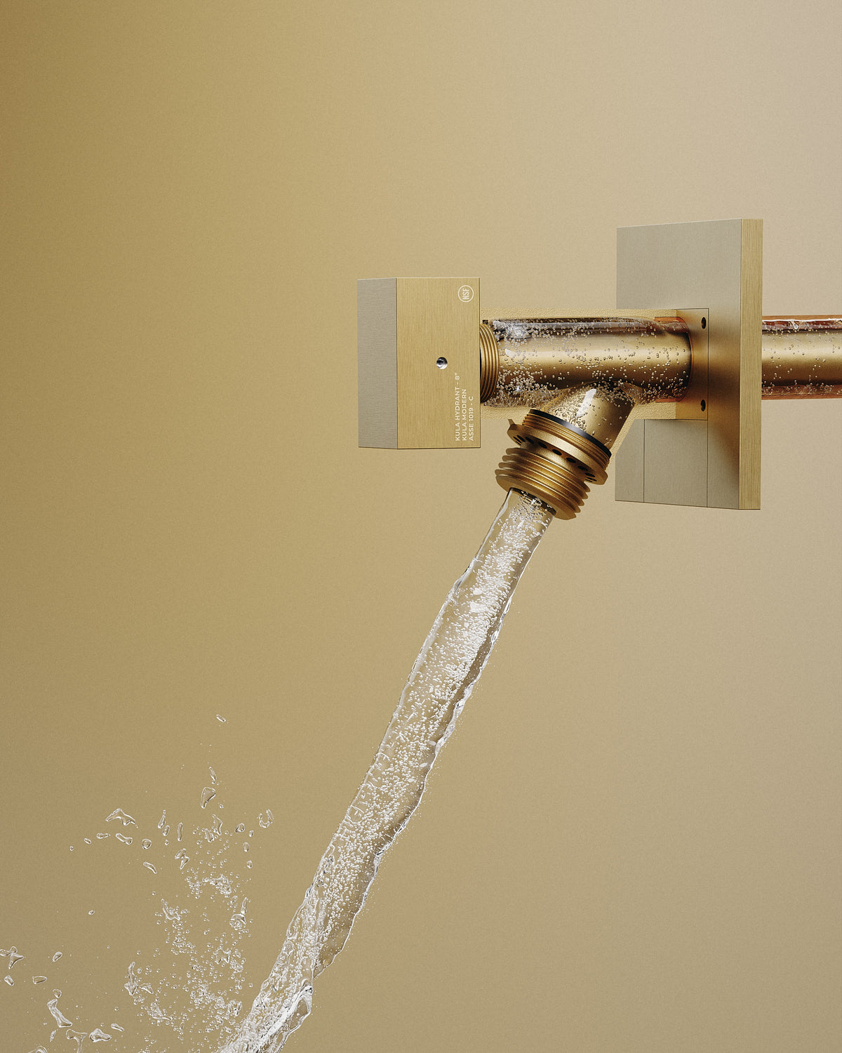 Kula Hydrant in Brushed Brass with water flowing from the outlet